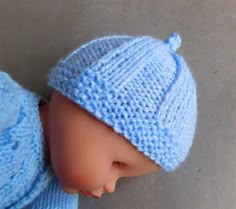 a baby doll wearing a blue knitted hat