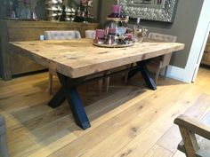 a wooden table sitting on top of a hard wood floor