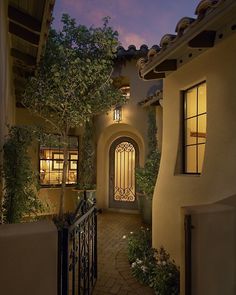 an entrance to a home at night with lights on