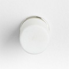 a close up view of a white knob on a wall with the light turned off