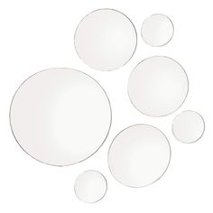 four white plates are arranged in the shape of circles