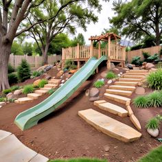 a wooden slide in the middle of a garden with steps leading up to it and trees