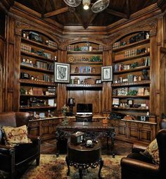 an office with wooden shelves and leather chairs