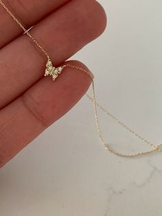 "14K Yellow Gold Gold Butterfly Necklace 16\"+2, Dainty Butterfly Chain, Minimalist Necklace, Layering Necklace, Butterfly Chain, Butterfly ♦ Materials: 14K Yellow Gold, Cubic Zirconia ♦ Available colors: Yellow Gold ♦ Necklace measurements: 16\" with a 2\" extender, for a total length of 18\". The chain is 1MM wide. The charm is 5MM -------------------------------------------------- ♦ -------------------------------------------------- MATERIALS All chains and pendants are made of 14K Solid Gold Tiny Butterfly Necklace, M Necklaces, Minimalist Jewelry Aesthetic, 14k Gold Butterfly Necklace, Gold Necklace Choker, Dainty Butterfly Necklace, Gold Dainty Necklace, Gold Butterfly Necklace, Jewelry Necklace Simple