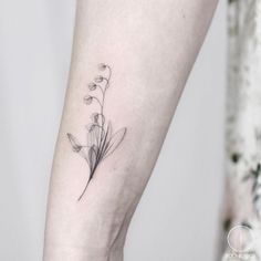 a small flower tattoo on the left inner arm and leg, with watercolor style flowers