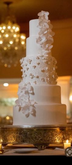 a white wedding cake sitting on top of a table