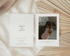 a wedding save the date card on top of a white sheet with an image of a couple kissing