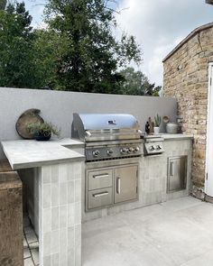 an outdoor kitchen with stainless steel appliances