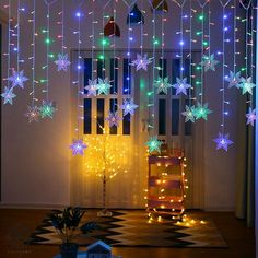 snowflakes are hanging from the ceiling in front of a door decorated with multi - colored lights