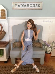 a doll is sitting on a chair in a room