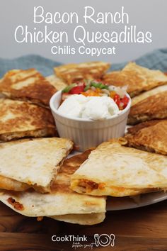 chicken quesadillas on a white plate with a small bowl of ranch dressing