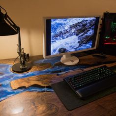 a desk with a keyboard, mouse and monitor on it