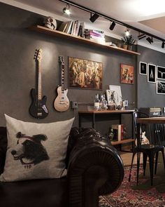 a living room filled with furniture and lots of clutter on the wall next to a desk