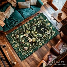 an overhead view of a living room with green couches and rugs on the floor