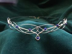 Beautiful handmade silver plated lapis lazuli circlet. The design is crafted from just two lengths of wire emulating traditional Celtic knotwork with beautiful blue lapis lazuli gemstones. The circlet is open at the back with loops for ribbon or cords to be attached to enable the circlet to be held in place. You can also pin it into place if preferred. The circlet is entirely handmade and therefore it is sturdy yet flexible and very comfortable to wear. The design element of the headdress measures 22.5cms (9 inches) across and 2.5cms (1 inch) from top to bottom at the centre. The full circumference of the circlet is 52cms (20 and a half inches). It is no problem to make the circlet smaller or larger, just leave a note with the size you would like it to be when you order. If you would like Elven Circlet, Wedding Circlet, Elf Jewelry, Tiara Headpieces, Headpiece Diy, Celtic Knotwork, Blue Lapis Lazuli, Wedding Tiara, Boho Bride