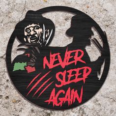 a sign that says never sleep again on the side of a stone wall with an image of a man holding a knife