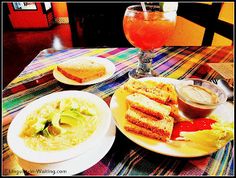 a table topped with plates of food and drinks