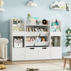 a living room with blue walls, white furniture and toys on the shelving unit