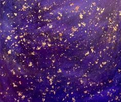 purple and gold speckles are on the surface of a blue cloth with white dots