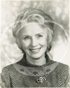 an old black and white photo of a woman with blonde hair smiling at the camera