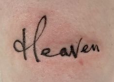 the word mean written in cursive writing on someone's back ribcage