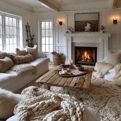 a living room filled with furniture and a fire place in the middle of the room