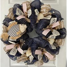 a wreath made out of burlocks and ribbons on the front door with an american flag theme