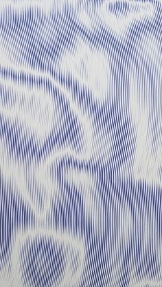 an abstract blue and white background with wavy lines in the shape of waves on it