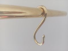 a close up of a metal hook on a white background