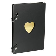 a black binder with a gold heart on the front and two metal hooks attached to it