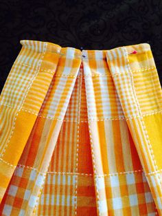 an orange and white checkered skirt with buttons