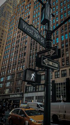 the street signs are clearly visible for everyone to see on this busy city street in new york