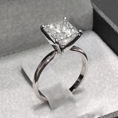 a diamond ring sitting in a box on top of a table