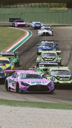 a group of cars driving down a race track