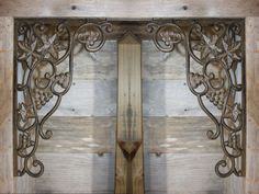 an ornate iron work on the side of a wooden door