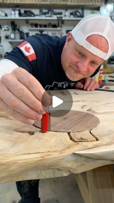 a man is cutting wood with a knife