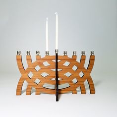 a wooden candle holder with two candles on it