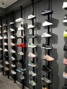 there are many pairs of shoes hanging on the wall