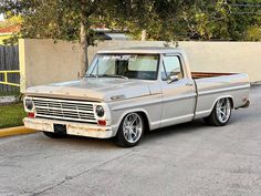 an old pickup truck parked in a parking lot