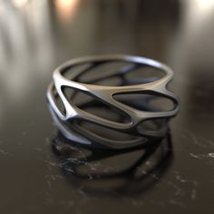 Introducing our Parametric Design 925 Sterling Silver Ring, a piece that embodies the fusion of art and mathematics. This ring is not just an accessory; it's a statement of modernity and innovation. The parametric design is a method of creating complex shapes and forms by using mathematical algorithms. Our ring captures this concept, showcasing intricate geometric patterns that are both visually stunning and intellectually stimulating. Handcrafted with 925 sterling silver, this ring is a testame Modern Titanium Ring, Ring Silver Men, Complex Shapes, Shapes And Forms, Parametric Design, Men Ring, Ring Minimalist, Minimalist Ring, Silver Gifts