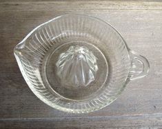 an empty glass bowl on a wooden table