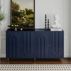 a blue cabinet sitting in front of a painting