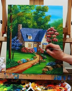 a person is painting a house in the woods with flowers and trees on easel