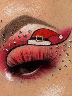 a woman's eye with santa clause makeup on her face and glitter eyeshadow