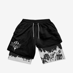 a black and white shorts with an image of a demon on the side, in front of