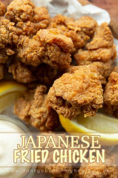 fried chicken is served with lemon wedges and mayonnaise on the side for dipping