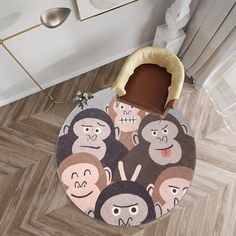 a round rug with monkeys on it in the middle of a living room, next to a chair