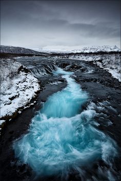 the water is blue and foamy as it flows