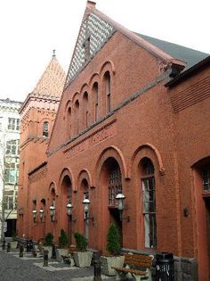 an old red brick building with arched windows