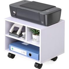 a printer is sitting on top of a book shelf